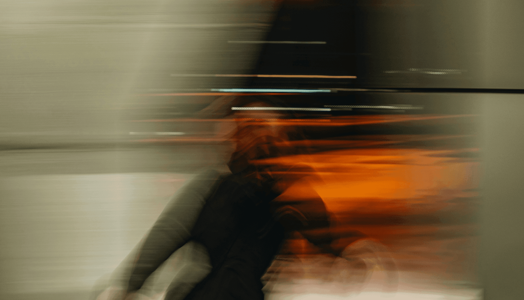 Blurred motion photo of a person running at night